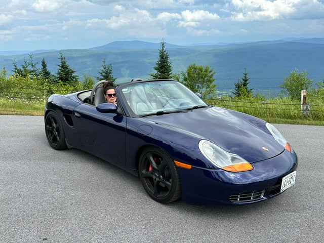 Dark blue convertible sports car parked at a mountain overlook